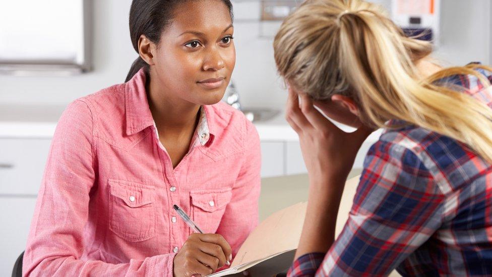 Dr speaking to woman