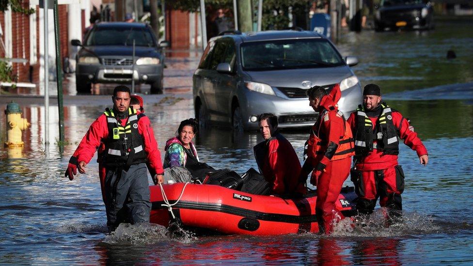 An emergency services team pulls residents of Mamaroneck, New York, in a dinghy through floodwaters from Hurricane Ida