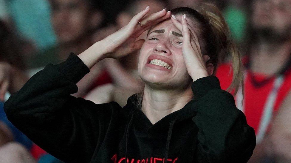 A Russian football fan in Samara, Russia, reacts as she watches a giant TV screen during the penalty shootout against Croatia, 7 July 2018