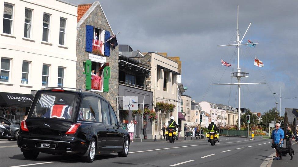 Hearse carrying Lieutenant Governor Air Marshal Peter Walker makes it way along the seafront on its way to the airport