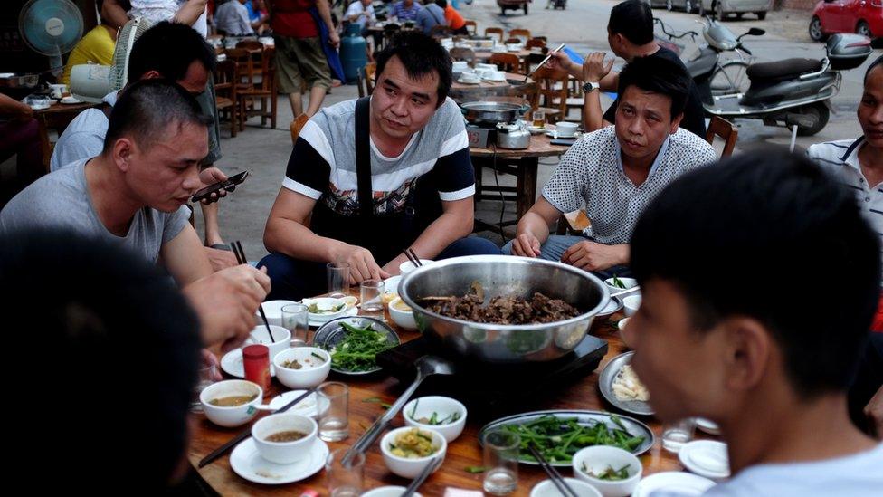 Diners around a dog dish