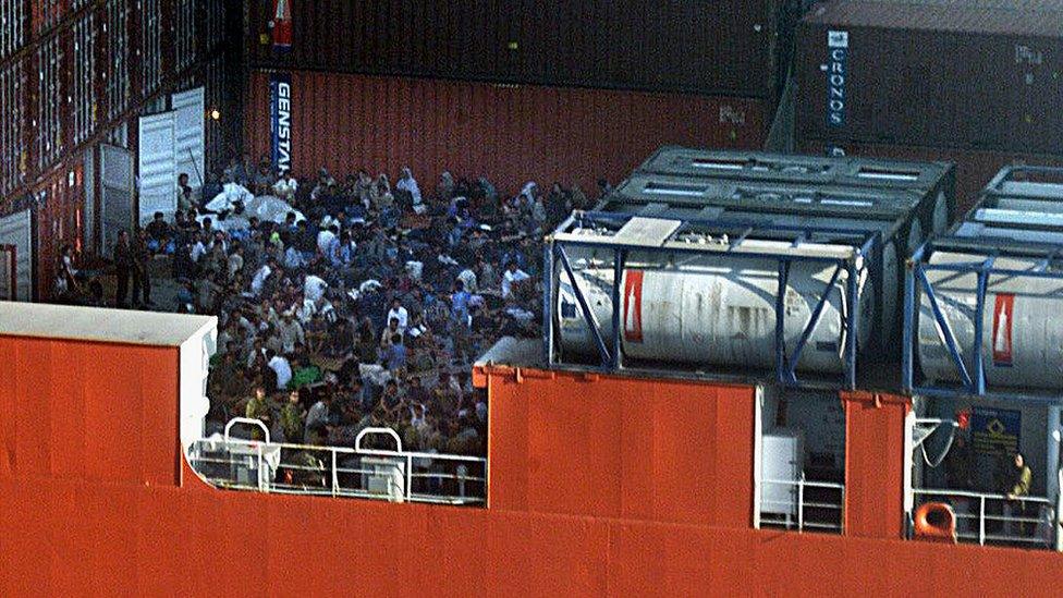 Asylum seekers crowd the deck of the MV Tampa in August 2001