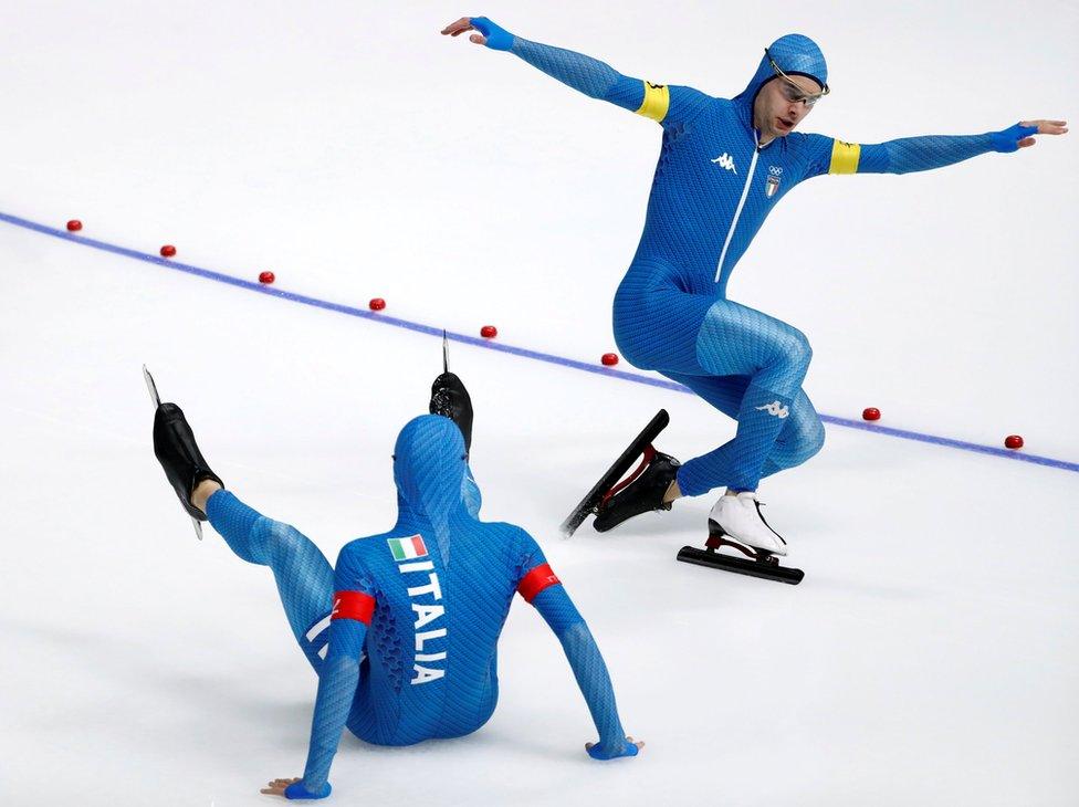 Nicola Tumolero and Riccardo Bugari seen on the ice, one with arms outstretched, the other sitting on the ice