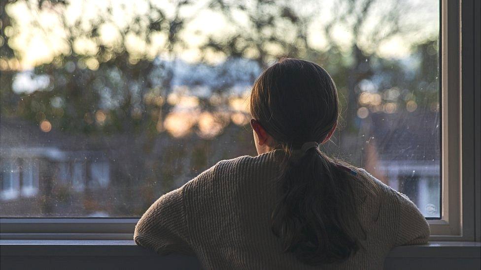 Girl looks out of window