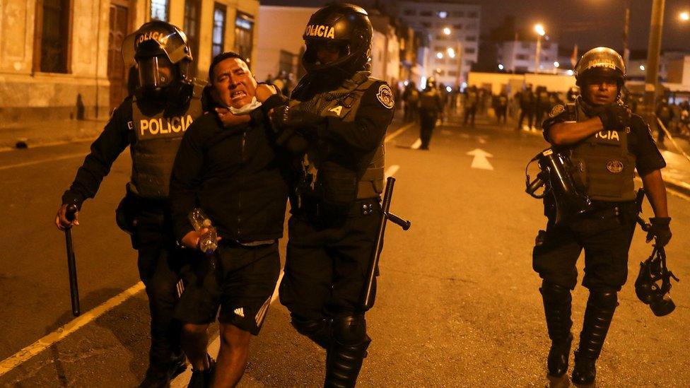 A demonstrator is detained by police officers during a protest demanding the dissolution of Congress and to hold democratic elections rather than recognize Dina Boluarte as Peru's President, after the ouster of Peruvian leader Pedro Castillo, in Lima, Peru December 11, 2022