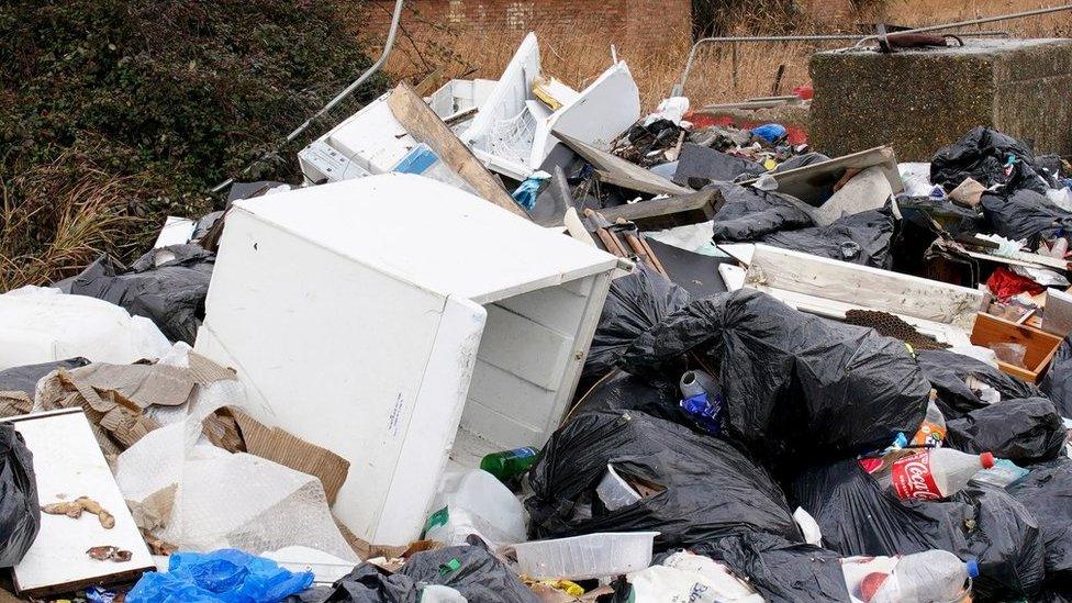 A pile of rubbish left at the side of the road