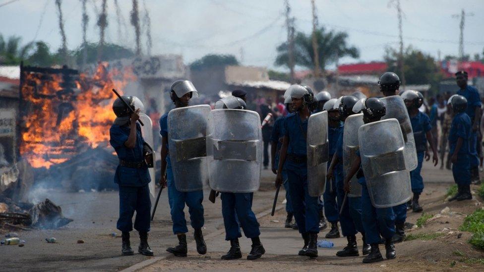 Police walk with shields through the Cibitoke neighbourhood of Bujumbura during May 2015 clashes