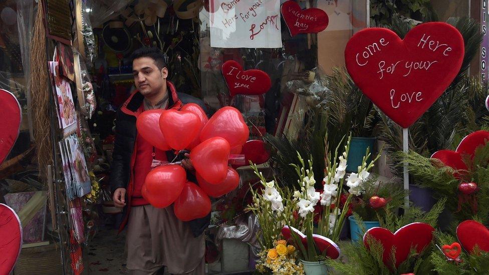 Man in Kabul holding red baloons