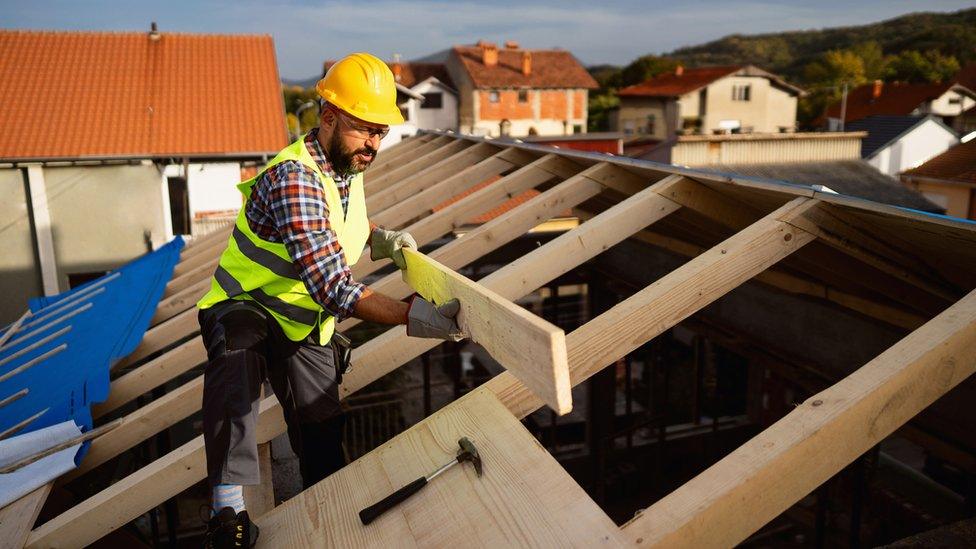 Worker building a house