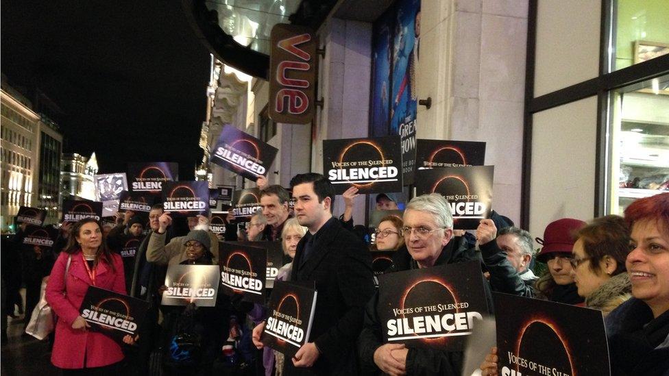 Group with banners outside cinema