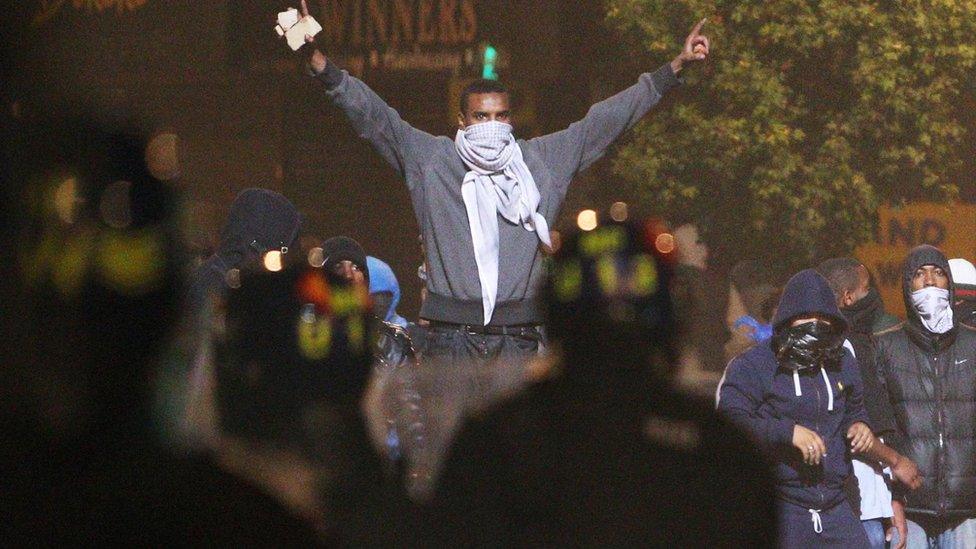 Riot police patrol the streets in Tottenham, north London