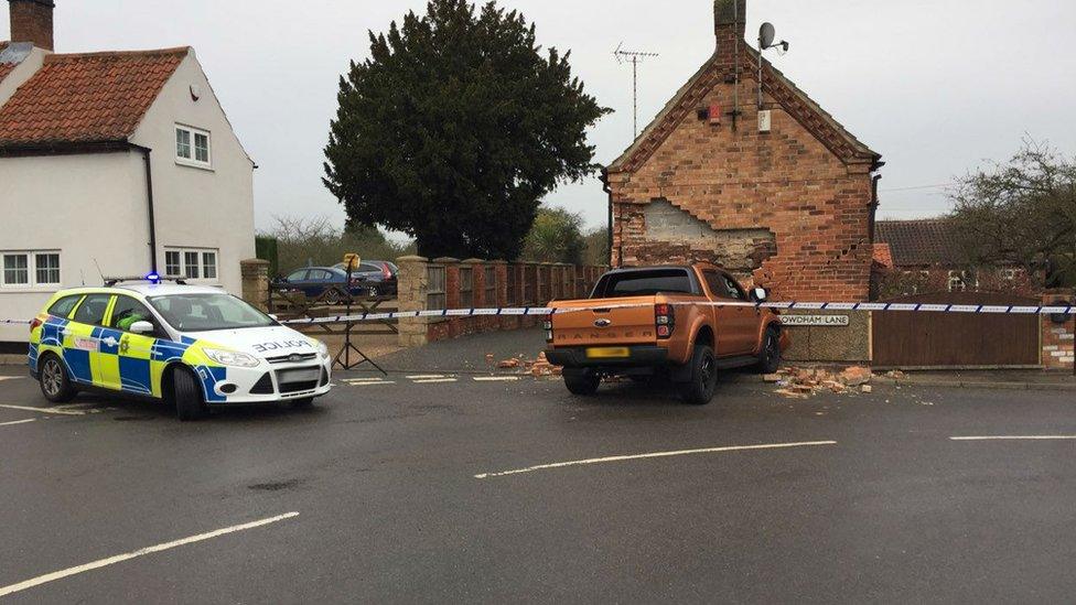 Truck in front of damaged house