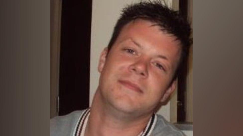 Image of Daniel O'Sullivan, a man with brown hair wearing a grey top