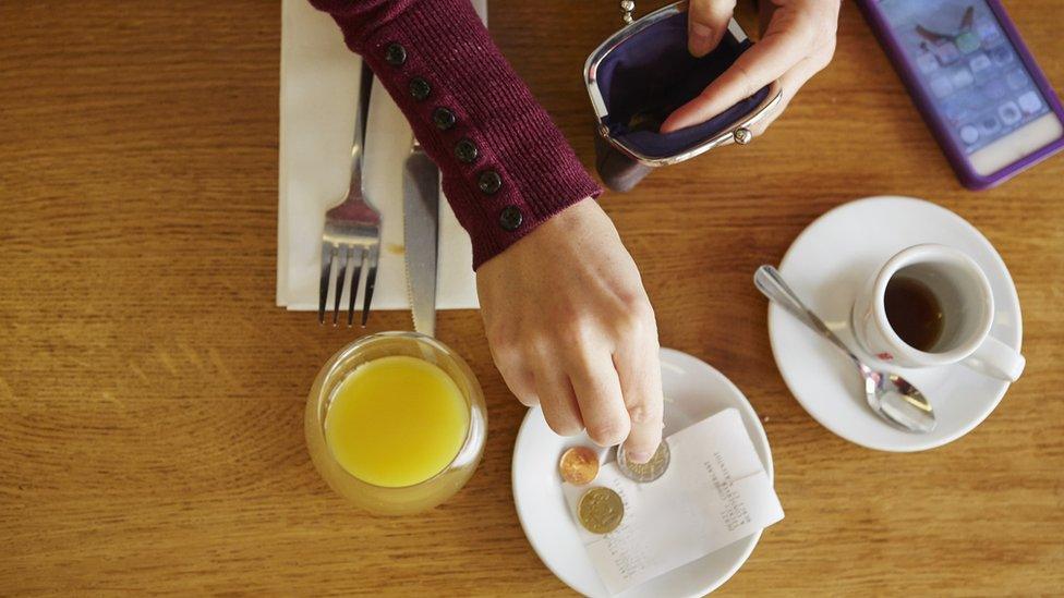 Woman paying a tip in cash