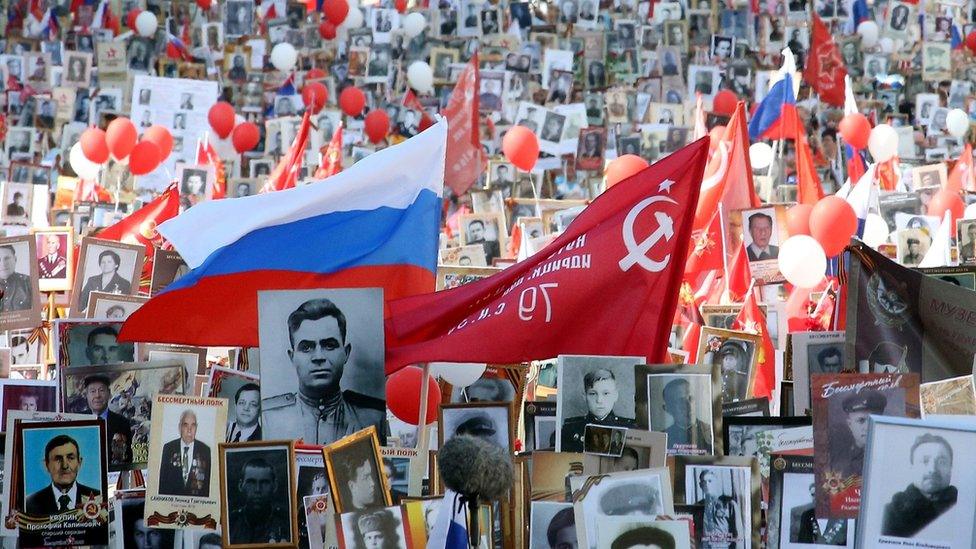 Russian people carry flags and portraits of relatives who took part in World War Two during a commemorative march titled Immortal Regiment in Moscow, Russia, 09 May 2016