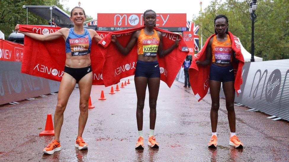 First place Brigid Kosgei of Kenya, second place Sara Hall of The United States of America and third place Ruth Chepngetich of Kenya pose for a photo following competing in the Elite Women's Field during the 2020 Virgin Money London Marathon