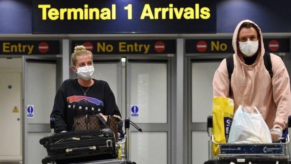 Couple reaching arrivals at a UK airport