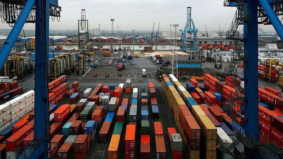 Ship freight containers sit on Tilbury Dock