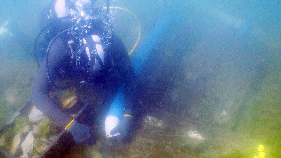 Diver during expedition exploring the vessel