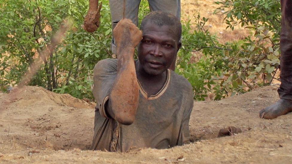 A miner being lowered into a mine at Barkin Ladi