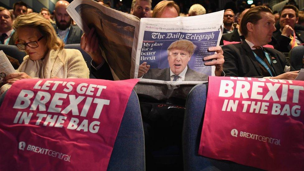 A delegate reads The Daily Telegraph as they attend the annual Conservative Party Conference on 30 September 2018 in Birmingham