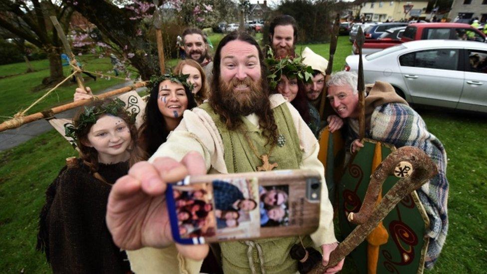 St Patrick, played by actor Marty Burns, took a selfie with members of the Magnus Vikings Association in Downpatrick, Northern Ireland