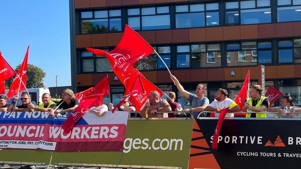 Striking Wrexham council workers at start line of tour of Britain in Chester Street outside a council building