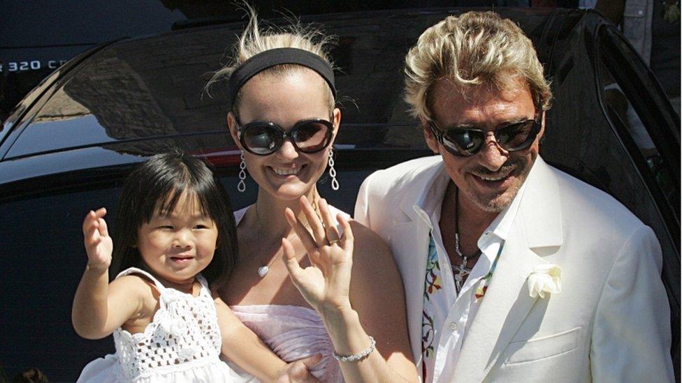 This file photo taken on July 29, 2006 shows French singer and actor Johnny Hallyday, his wife Laeticia and their daughter Jade