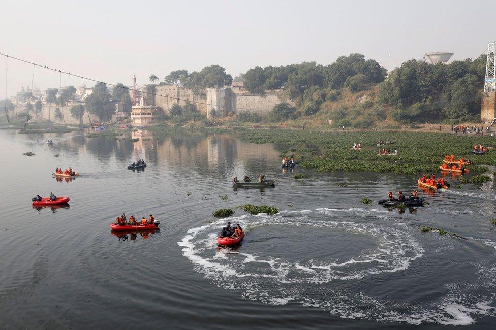 Rescuers conduct search operation after a suspension bridge collapsed on Sunday, in Morbi town in the western state of Gujarat, India, November 1, 2022. REUTERS/Stringer NO RESALES. NO ARCHIVES.