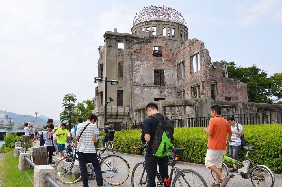 People play Pokemon Go near the Atomic Bomb Dome at Hiroshima Peace Memorial Park in Hiroshima on 26 July 2016.