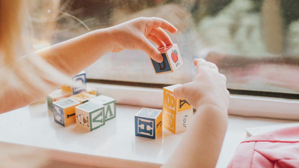 A girl playing with building blocks