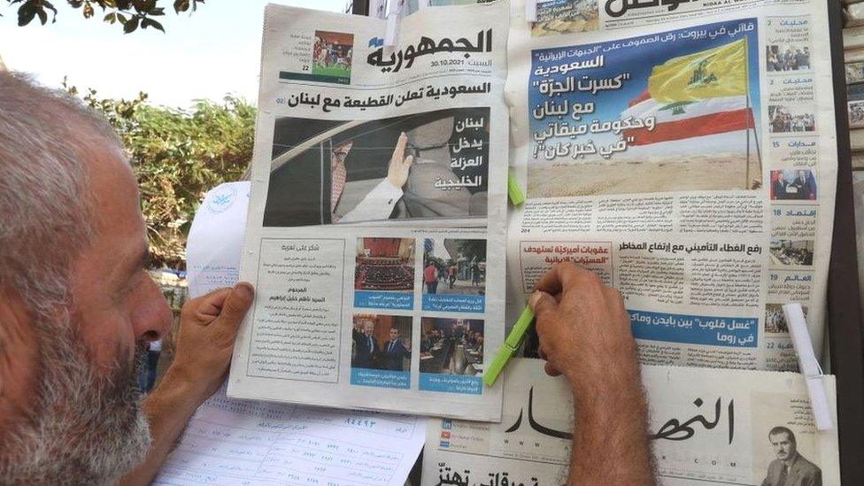 A newspaper vendor arranges newspapers at his stall in the Lebanese capital Beirut