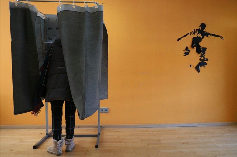 A woman votes during the general election in Madrid on 10 November 2019