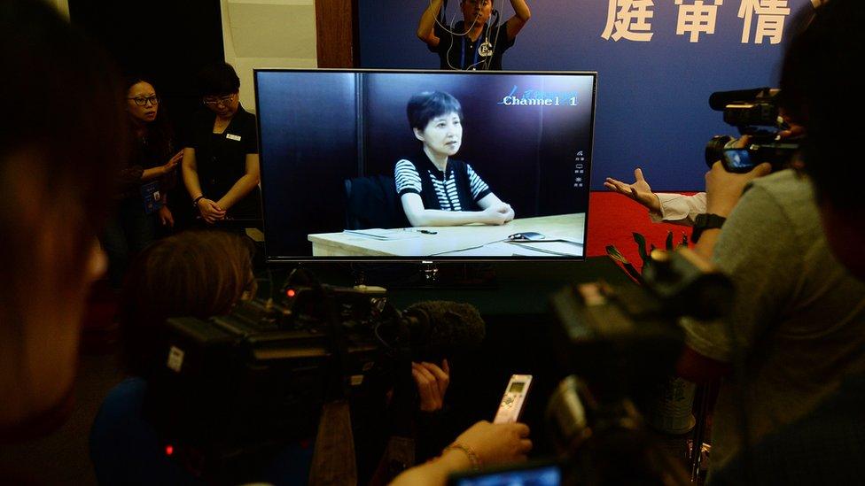 Gu Kailai (television screen) who is the wife of disgraced politician Bo Xilai gives a recorded testimony during his trial at the Intermediate People's Court in Jinan, Shandong Province on August 23, 2013