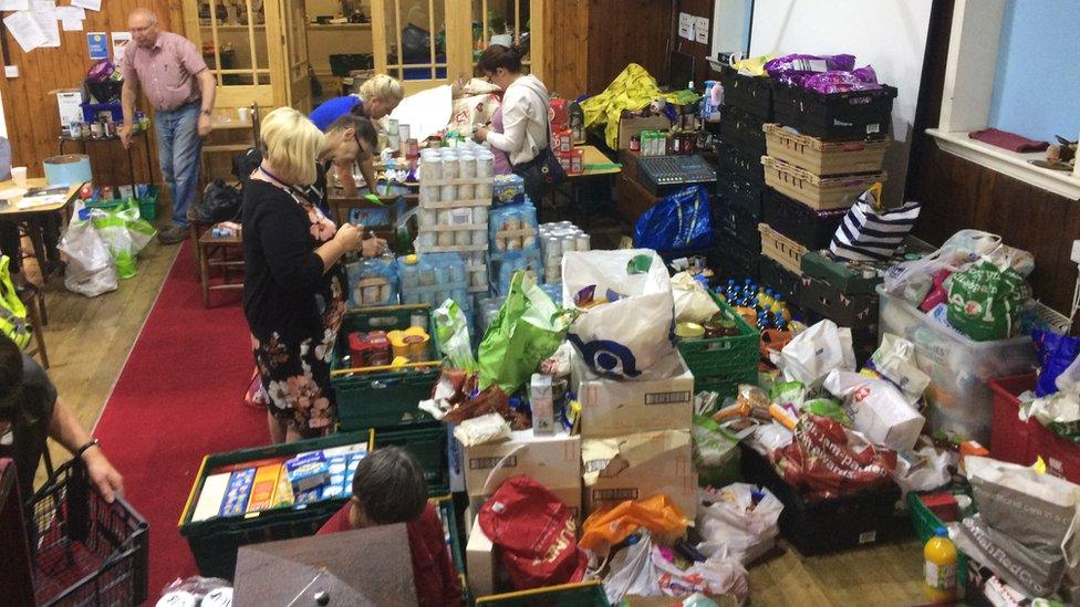 Volunteers sort through the supplies donated to Eastside Food Bank