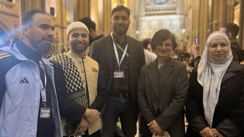 Five people pictured together inside the cathedral