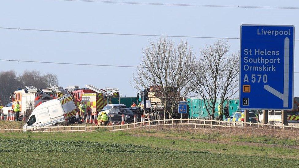 Multi-vehicle crash on M58 showing white van crashed into a nearby field