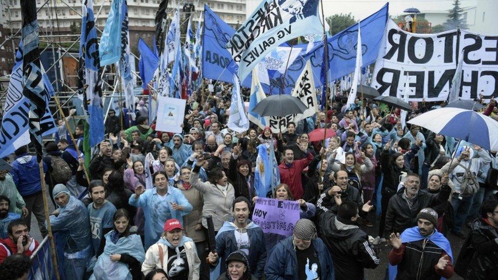 Supporters of Argentine former president Cristina Fernandez de Kirchner listen to her speech in front of the Comodoro Py courthouse where she testified before federal judge Claudio Bonadio over corruption allegations, in Buenos Aires on April 13, 2016.