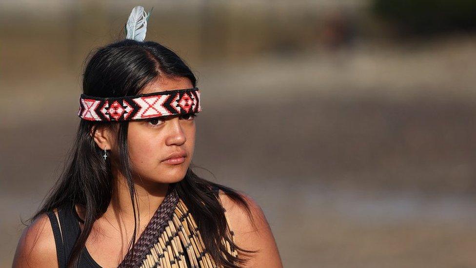 A girl waits to board the waka at the waka camp on February 06, 2021 in Waitangi, New Zealand.