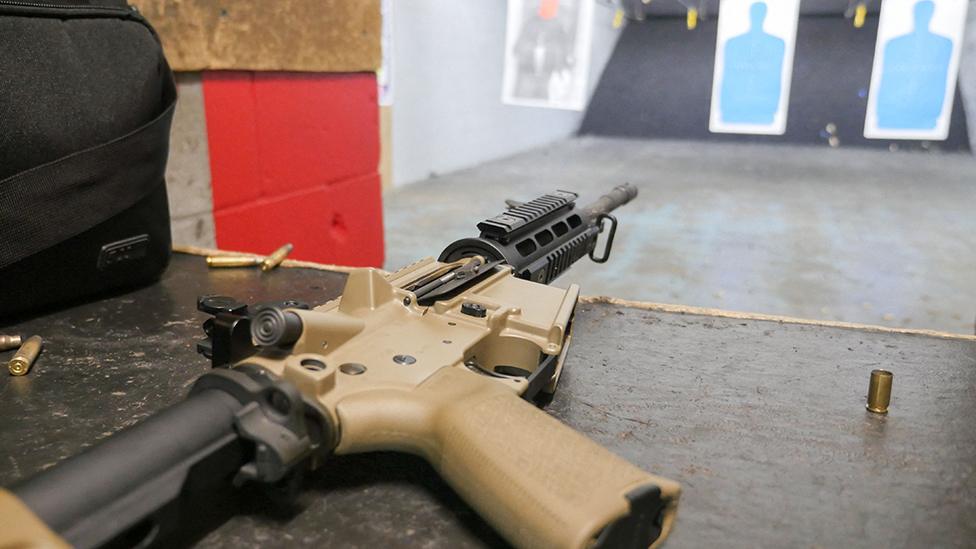 An AR-15 rifle and ammunition at a firing range