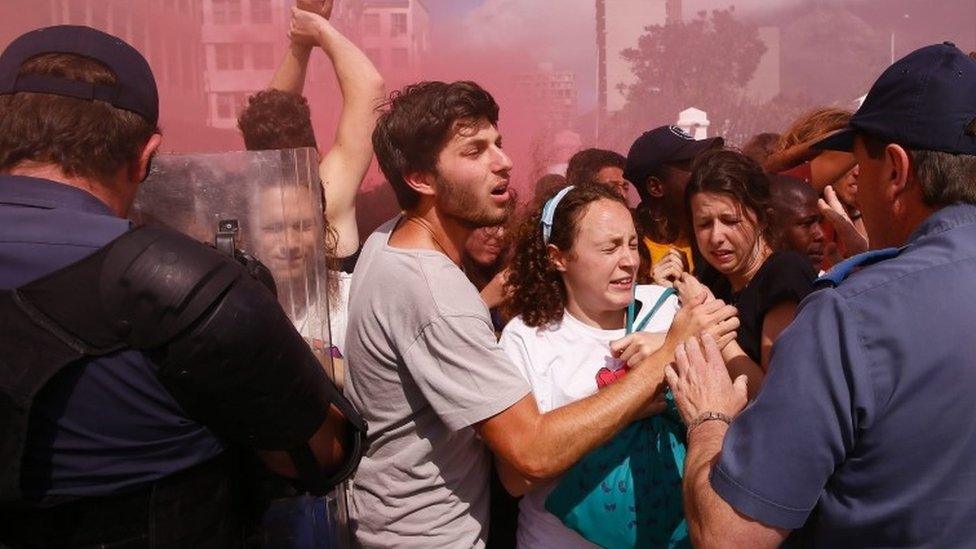 South African students clashe with police amidst gas and stun grenades during violent protests in the parliament precinct, Cape Town, South Africa, 21 October 2015