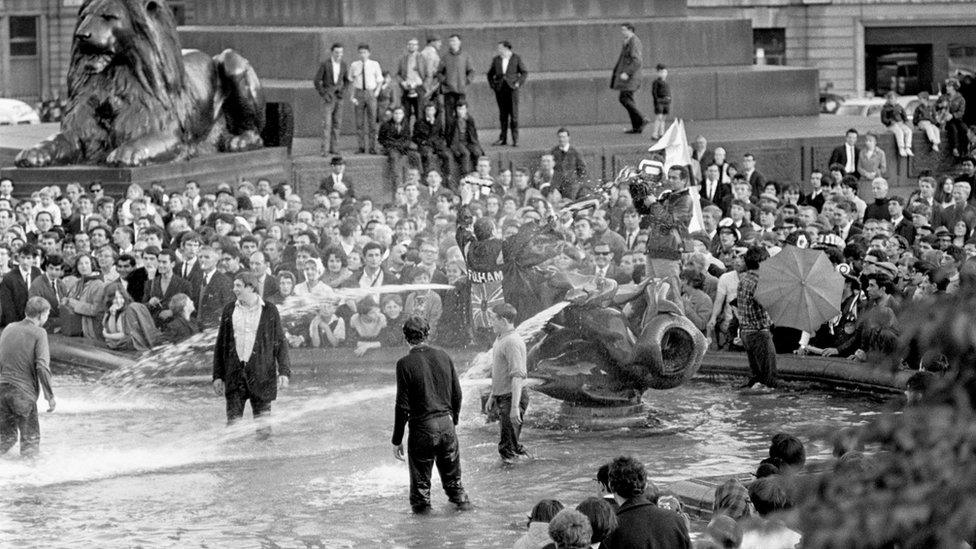 England fans celebrate winning the World Cup in the fountains at Trafalgar Square, London