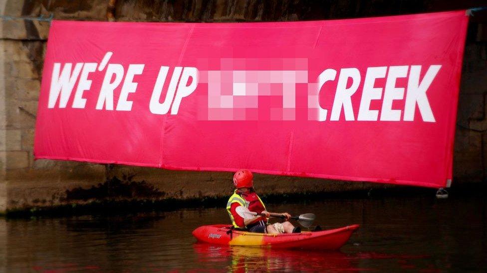 Extinction rebellion put up banners on bridges along the River Avon