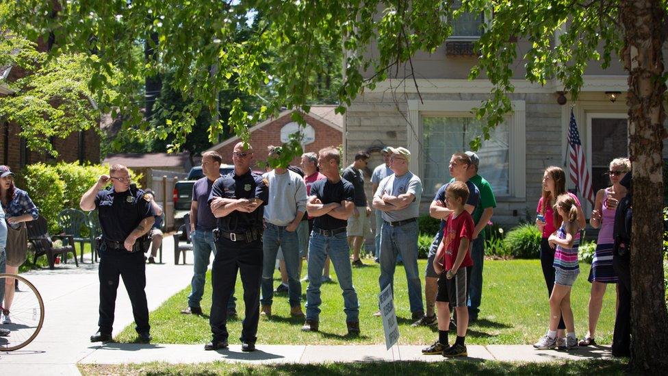 Police stand outside the house of Prosecutor Timothy McGinty as people protest in reaction to Cleveland police officer Michael Brelo being acquitted of manslaughter charges after he shot two people at the end of a 2012 car chase in which officers fired 137 shots May 23, 2015 in Cleveland, Ohio