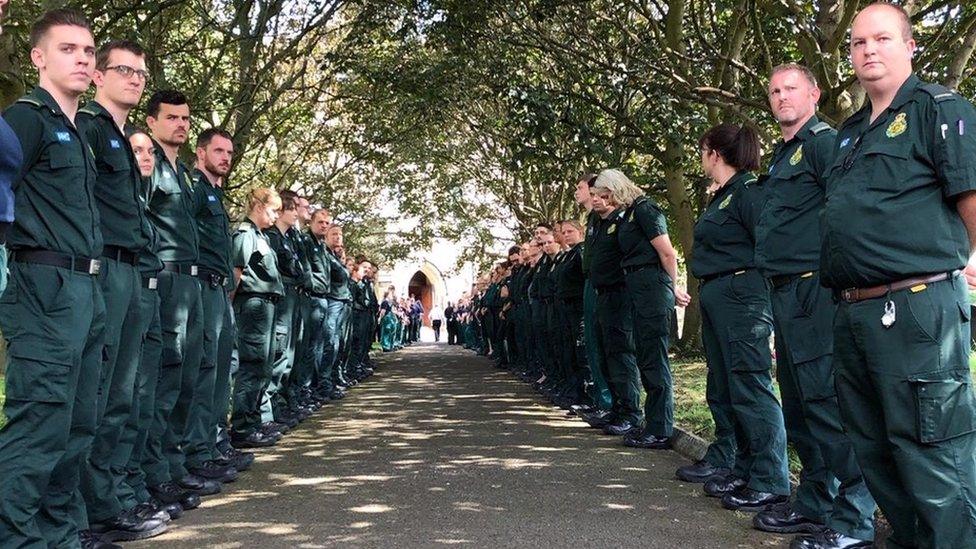 Paramedics lining the path to the church