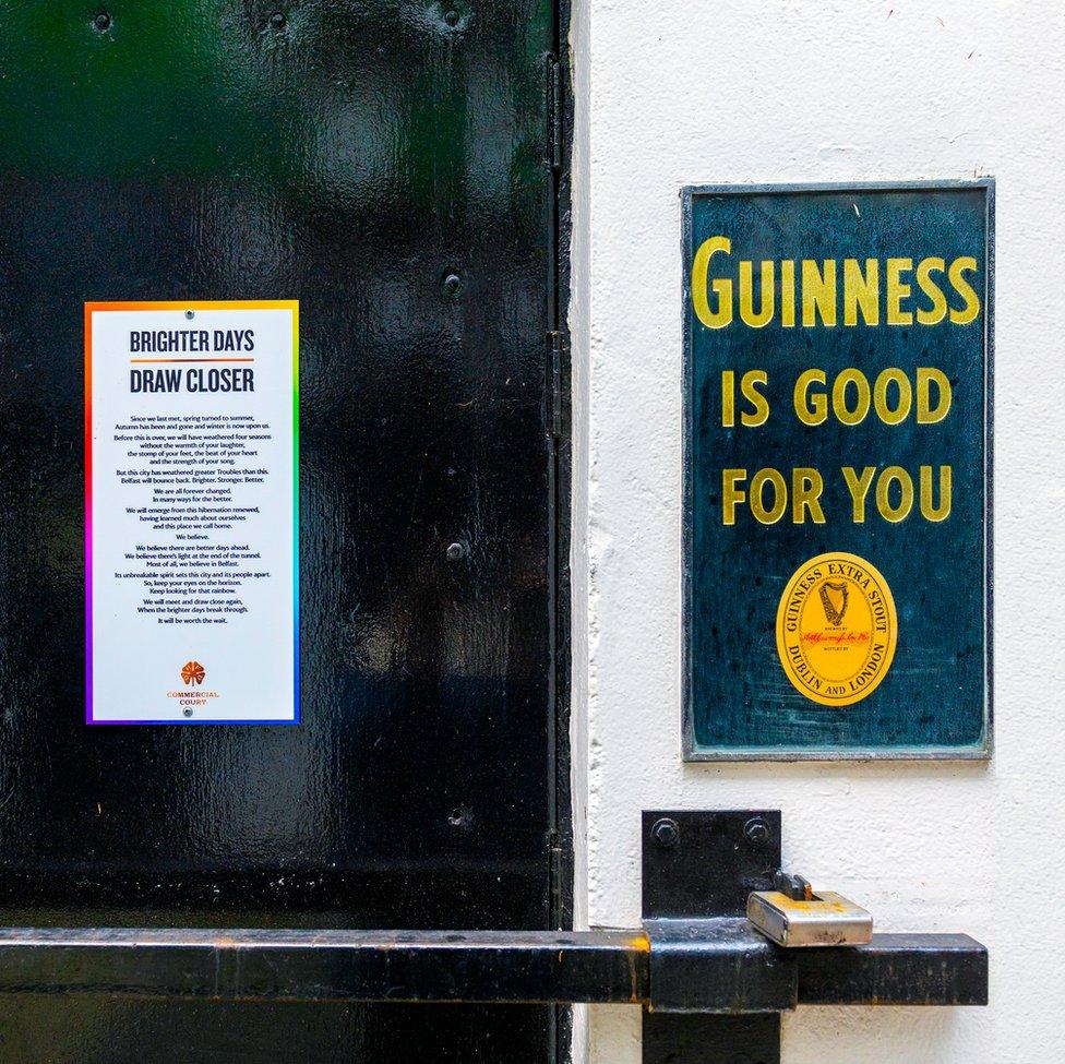 An image of a closed door next to a Guinness sign