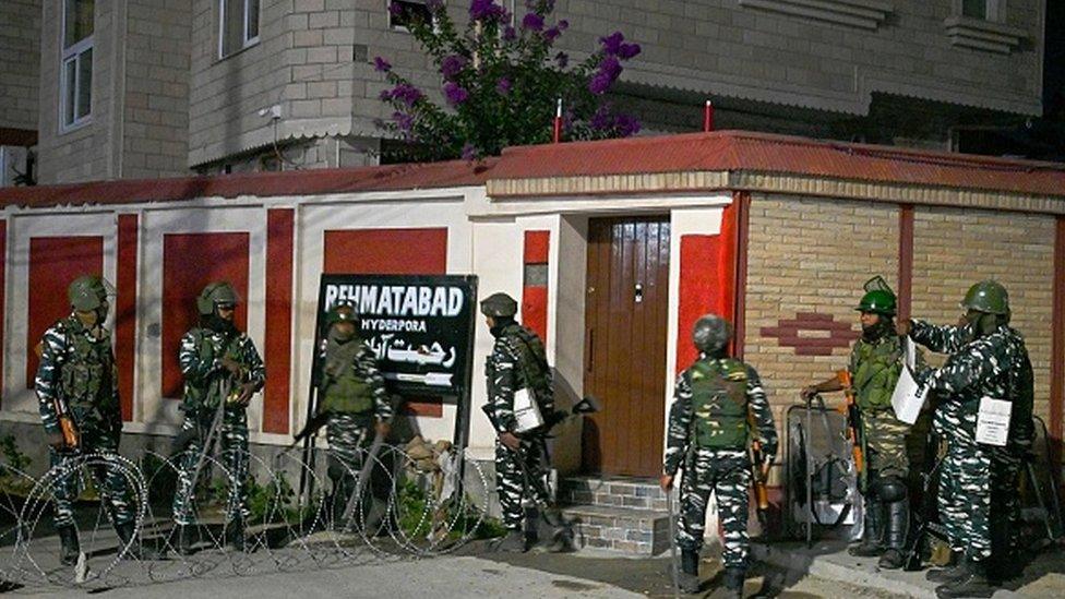 Indian paramilitary soldiers stand guard near the residence of Kashmiri separatist leader Syed Ali Shah Geelani after his death at the age of 92