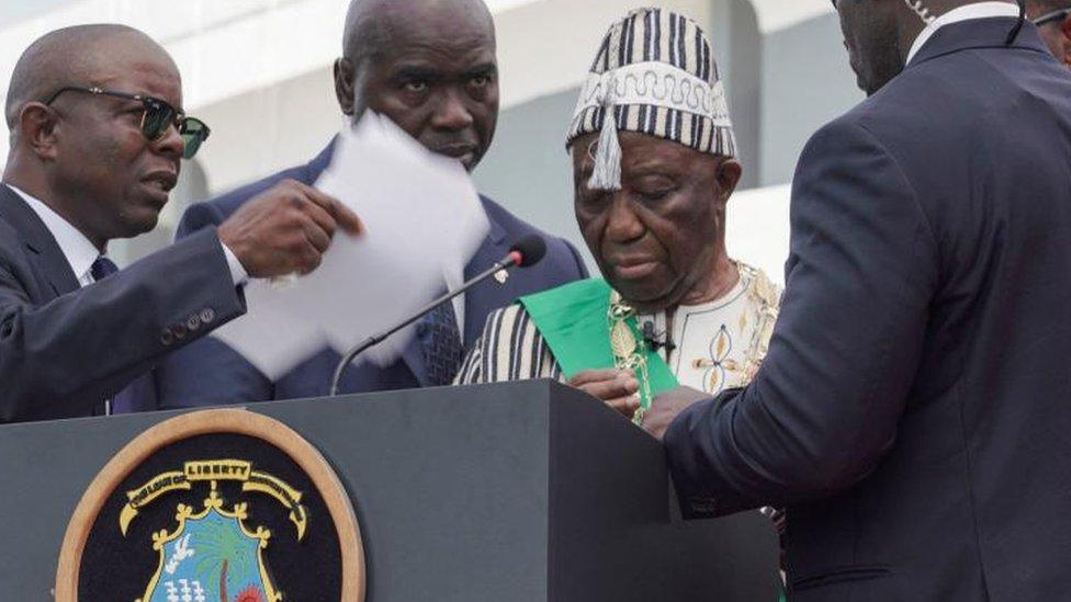 Presidential bodyguards rush to surround Liberia's president-elect Joseph Boakai, who suddenly paused his inaugural speech after his swearing-in as president during the inauguration ceremony in Monrovia Liberia January 22, 2024