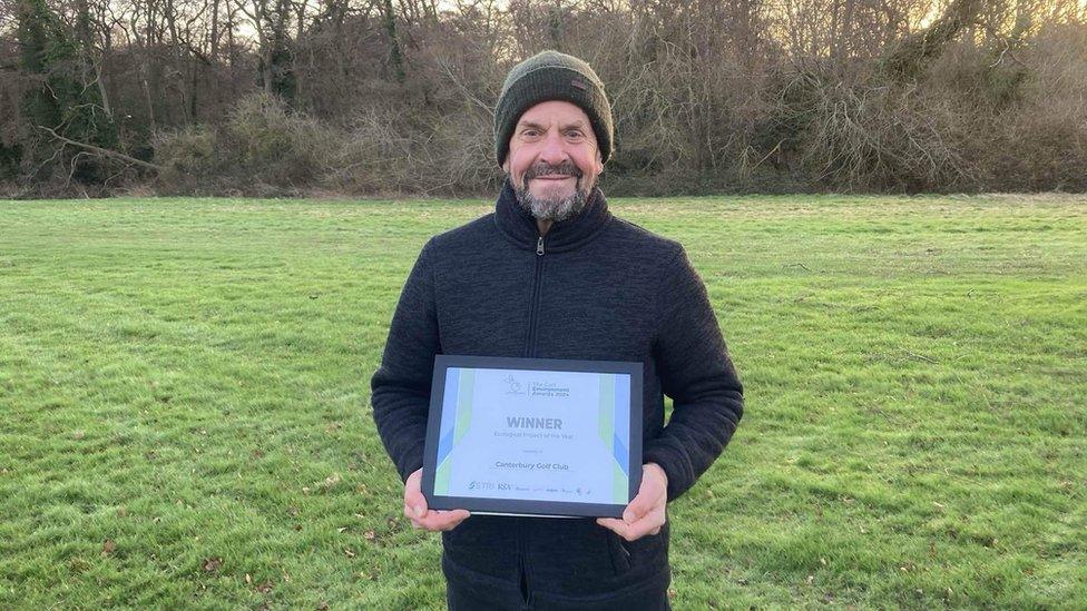 Ray Goodsall holding the award