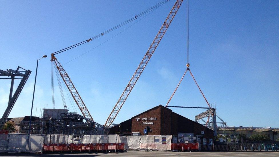 A crane helps to lower the bridge into place